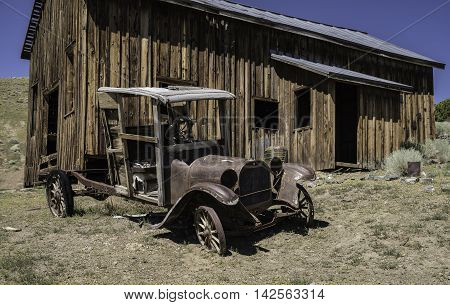 Remains of a 1918 Dodge Truck sits outside an abandoned building in Berlin, NV ghost town.