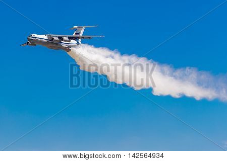 August 6 2016. Ryazan Russia. The aircraft of the Military Air forces of Russia perform aerobatics at an Airshow. The aircraft puts out the fire releasing water. Documentary Editorial Image.