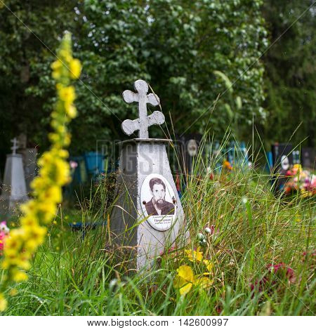 SOGINICY, RUSSIA - JUL 30, 2016: Cemetery on site of Church of Nichola. Church of St. Nicholas at Soginicy, the only surviving sample of a steepled Church prionezhskiy school, 1696 built.