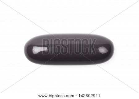Black medical drug pill isolated over the white background