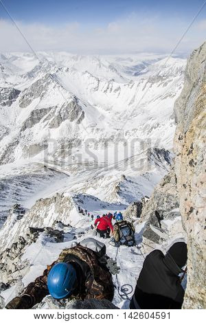 Tourists The Chain Climb To The Top Of The Mountain.