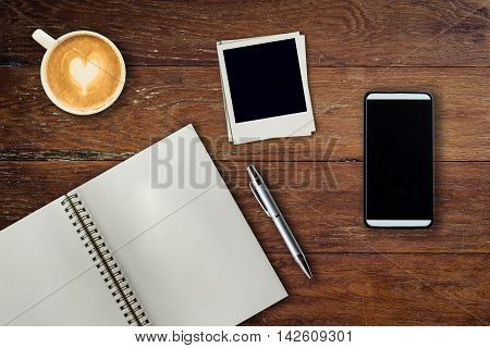 Mobile Phone, Notebook Pen, Photo Frame And Coffee Cup On Office Wooden Table With Copy Space.