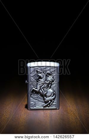 Lighter on a wooden floor in the dark