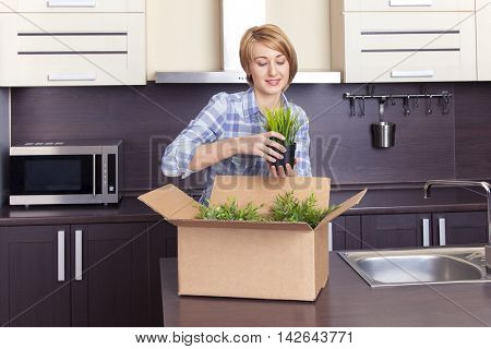 beautiful girl in blue shirt is decorated with flowers kitchen
