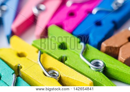 a heap of color wooden clothes pins