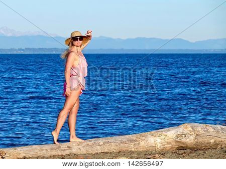 Woman on beach by sea. Boundary Bay Provincial Park Tsawwassen British Columbia Canada.