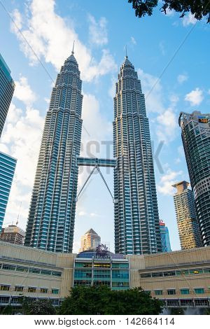 KUALA LUMPUR MALAYSIA - FEBRUARY 29: Petronas Twin Towers during evening on February 29 2016 in Kuala Lumpur Malaysia. Petronas Twin Towers with Suria KLCC Mall.