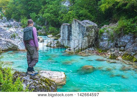 A fly fisherman fishing in a river