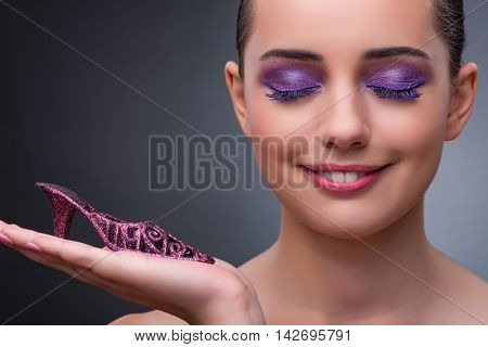 Young woman with purple show in fashion concept