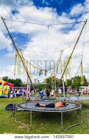 Perekhrest Ukraine - August 14. 2016: Man sleeping on a trampoline during the first festival of hunters.