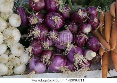Red onions sold as is on a rural market