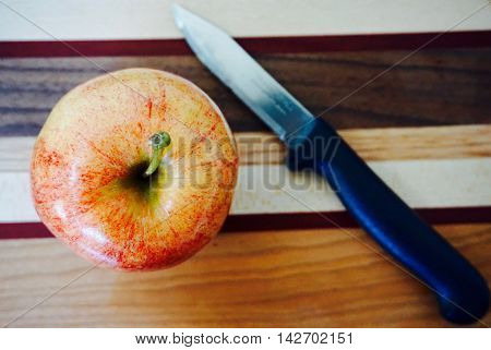 Apple on cutting board awaiting its slice