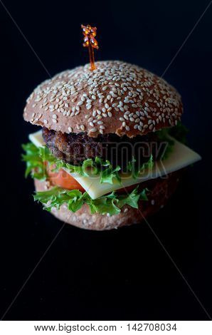 Hamburger with salad cheese tomato meat on white backdrop. Popular snack.
