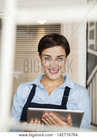Happy Fashion Designer Holding Digital Tablet At Factory