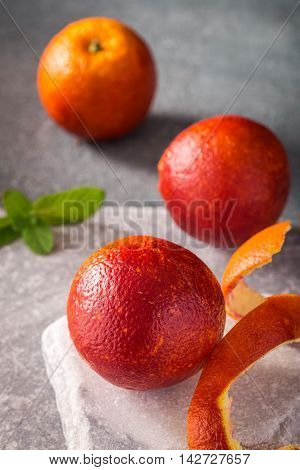 Three blood oranges on stone background closeup