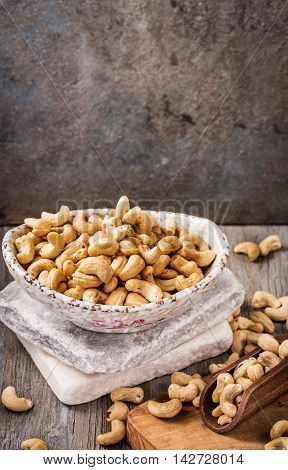 Bowl of cashew on old table with grunge copy space