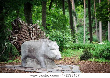 Sculpture of wild boar in forest  of Latvia