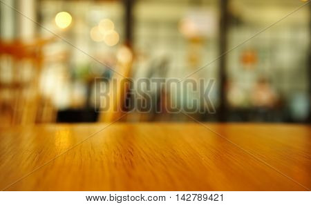 bright wood table top surface with blur cafe interior background