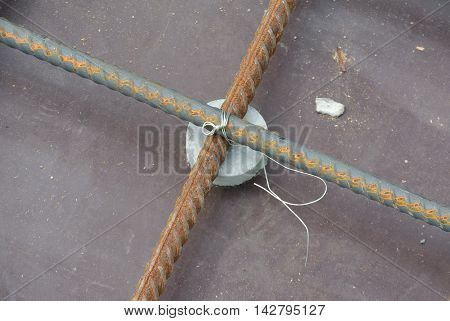 SELANGOR, MALAYSIA -SEPTEMBER 19, 2015: Hot rolled deformed steel bars or steel reinforcement bar and the concrete spacer. The spacer used to created gap between reinforcement bar and the form work.