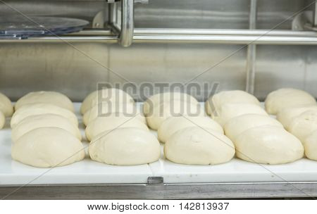 Fresh baked bread on racks and pans in a commercial kitchen