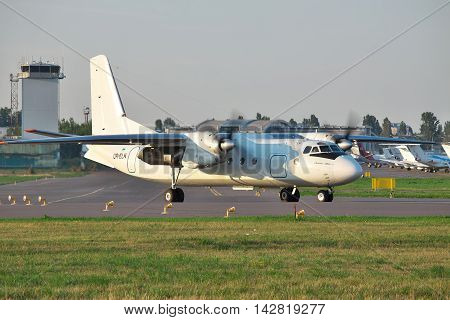 Kiev Ukraine - July 27 2012: Antonov An-24 turboprop passenger plane is taxiing to the runway before takeoff