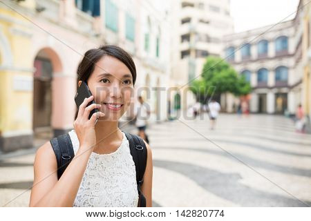 Woman talk to cellphone in senado square