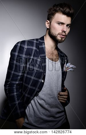 Portrait of handsome modern stylish man over gray background. Hypster gay