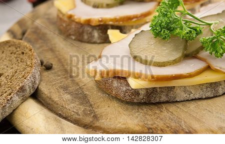 Sandwich With Meat And Chease On Cutting Board. Soft Focus