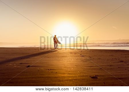 Beautiful beach lansdscape with surfers ready to hit the waves