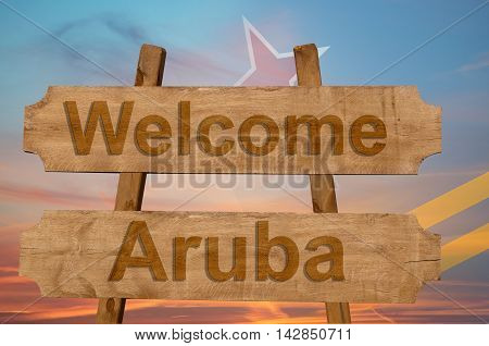 Welcome To  Aruba Sing On Wood Background With Blending National Flag