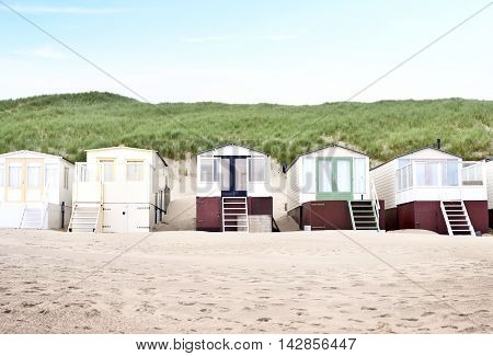 beach huts or houses and clear sky. Beach huts in front of a beach dune.