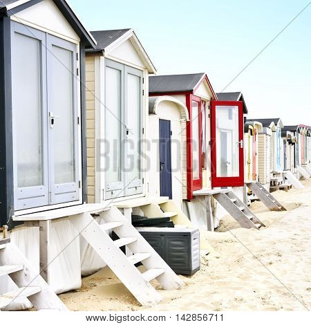 beach huts or houses and clear blue sky. Multicolored beach huts in in a row.