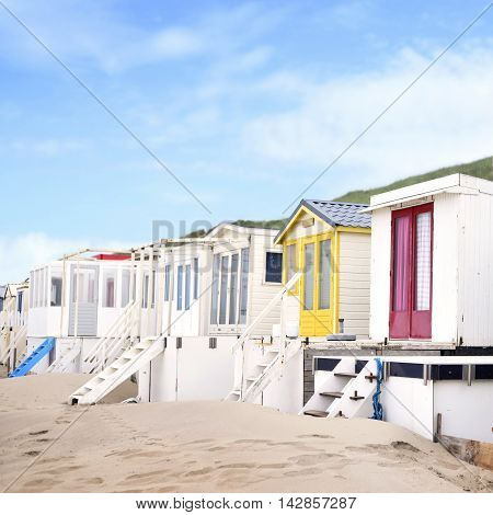 beach huts or houses and clear blue sky. Multicolored beach huts in in a row.