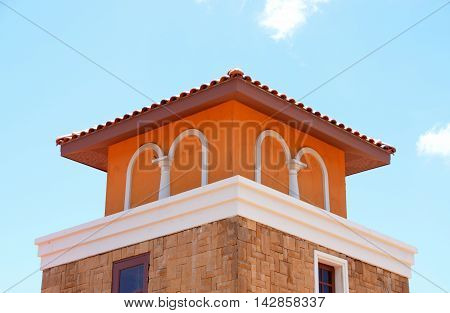 Orange European tower on blue sky day