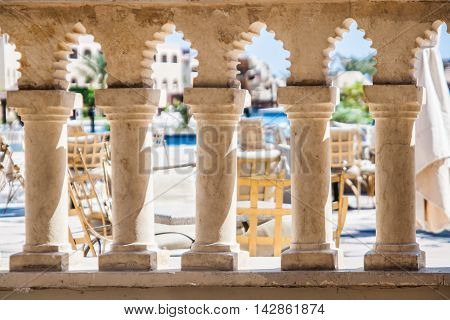 through the columns visible in the Arabic style restaurant tables. Hotel Sentido. Hurghada. Egypt. September 2011.