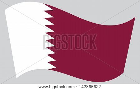 Flag of Qatar waving on gray background. Qatari national flag.