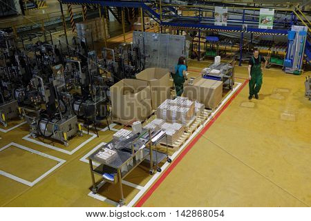 ST. PETERSBURG, RUSSIA - AUGUST 11, 2016: Worker at beer conveyor in the Heineken brewery. It was the first Heineken brewery in Russia, and now it can produce over 5 millions HL of beer per year