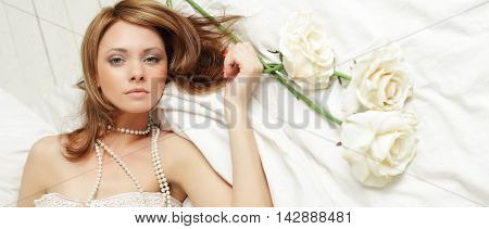 Fashion portrait of young sensual woman in bed