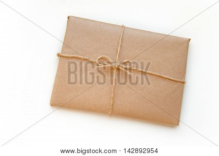 Vintage package tied up with string isolated on a white background