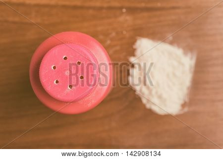 Baby talcum powder container over a wooden table