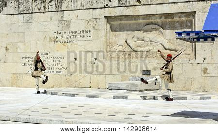 ATHENS GREECE - JUNE 04: 2016. Evzones (presidential guards) watches over the monument of the Unknown Soldier in front of the Greek Parliament Building at Syntagma Square on June 04 2016 in Athens Greece.