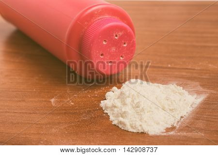 Baby talcum powder container over a wooden table