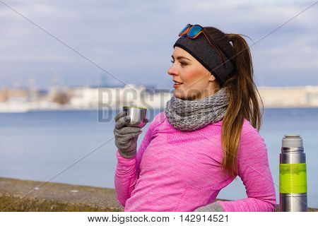 Fit Woman In Cold Day Warming Up Drink Tea