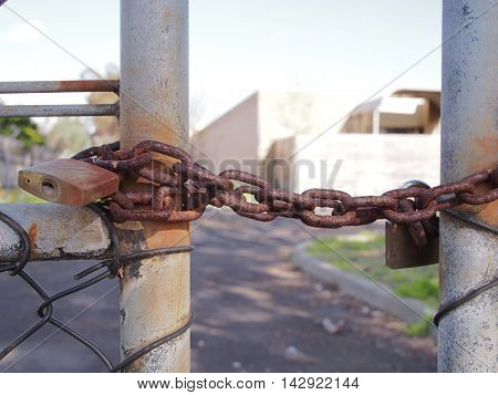 Melbourne Australia -August 4 2016: Lock on a wire security fence in fron of an industrial style building