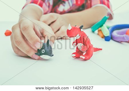 Child Molding Model Clay, On White Background. Strengthen The Imagination. Vintage Tone Effect.
