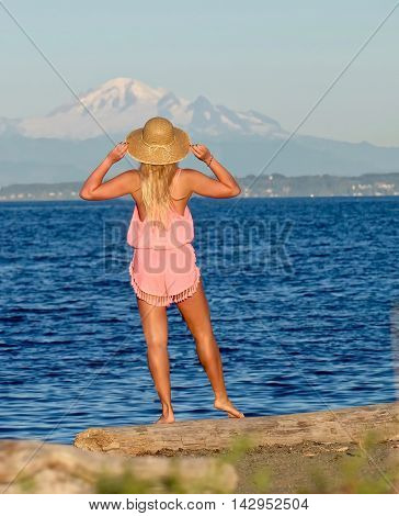 Young girl on beach looking at mountain. Centennial Beach in Boundary Bay Regional Park Tsawwassen British Columbia Canada