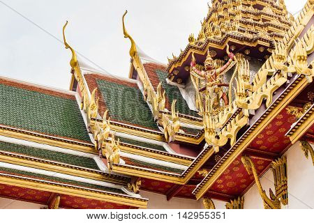 BANGKOK THAILAND - MARCH 28 2016: Detail of carvings on temple roof at Wat Phra Kaew the most sacred Buddhist temple and the most famous tourist attraction in Bangkok Thailand.