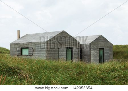 modern minimalist wooden houses surrounded by lawn