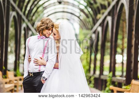 Elegant bride and groom posing together outdoors on a wedding day