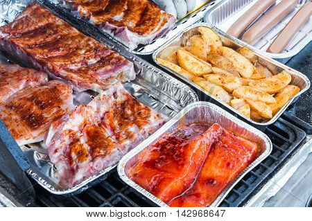 Different tasty grilled meat and sausages on a grill
